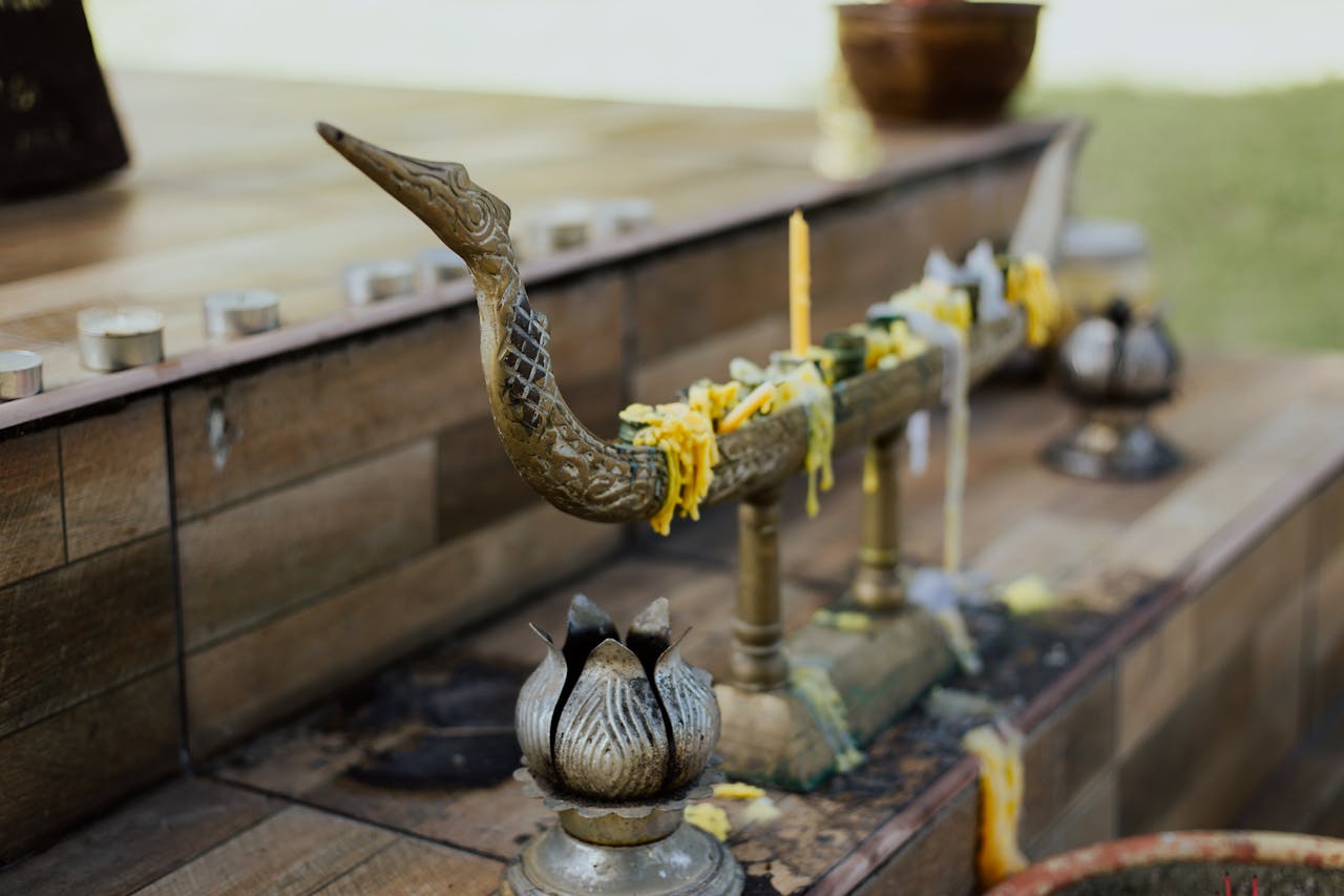 A close-up view of a Buddhist altar featuring detailed religious items, candles, and vibrant colors.